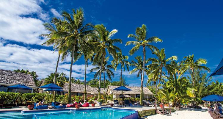 Palmbomen en een zwembad bij een resort aan het strand