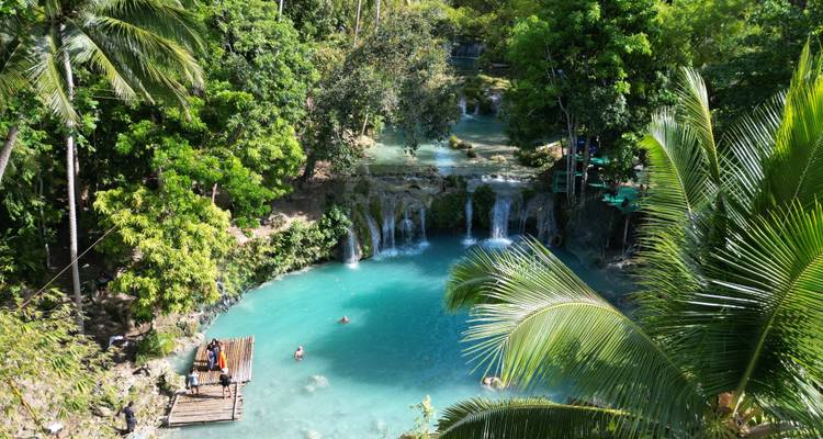 Menschen, die in einem natürlichen Pool schwimmen, umgeben von Bäumen