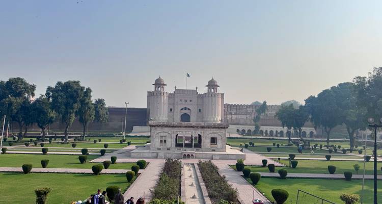 Marble pavilion amid gardens inside Lahore Fort, view captured from elevated terrace.