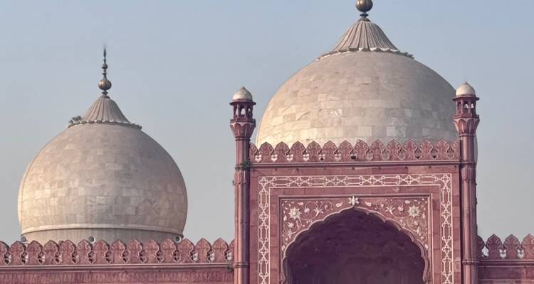 Detail of twin domes and intricate arch of Lahore's Badshahi Mosque.