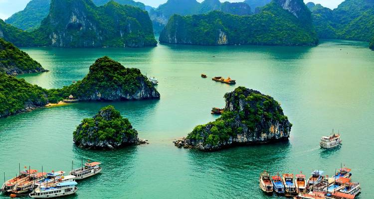 Panoramic view of Halong Bay with boats and limestone islands.