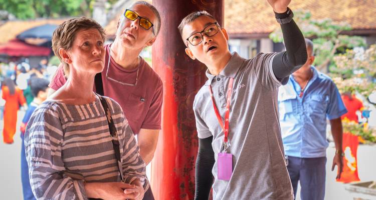 Visitors observing a guide pointing towards something.