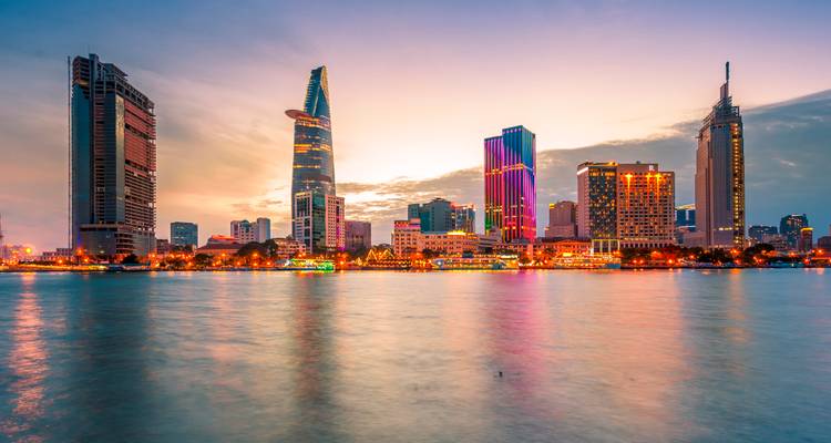 City skyline with modern skyscrapers and reflections on the water.