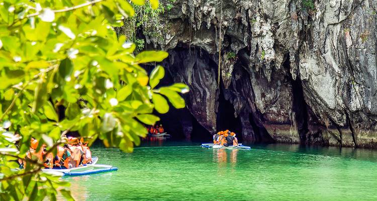 Visitors paddle small boats into the emerald entrance of Puerto Princesa’s subterranean river cave.