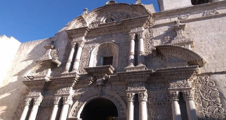 Ornately carved baroque façade of a colonial church in warm afternoon light.