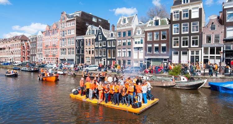 Canal with participants in orange attire celebrating.
