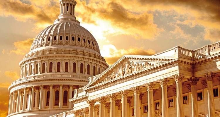 Close-up of the United States Capitol with a golden sky.