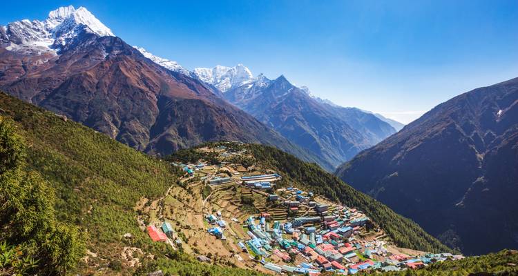 Sweeping aerial of Namche Bazaar amphitheatre village surrounded by soaring peaks