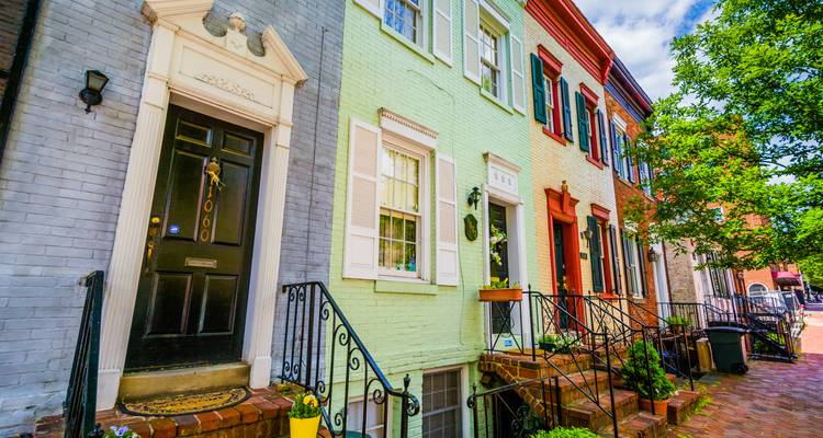 Colorful row houses with vibrant facades on a sunny day.