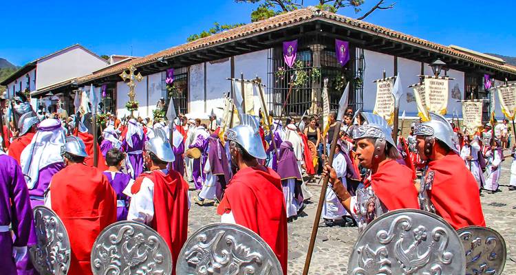 Les participants en costume vêtus de robes rouges et violettes marchant dans une procession vibrante de la Semaine sainte