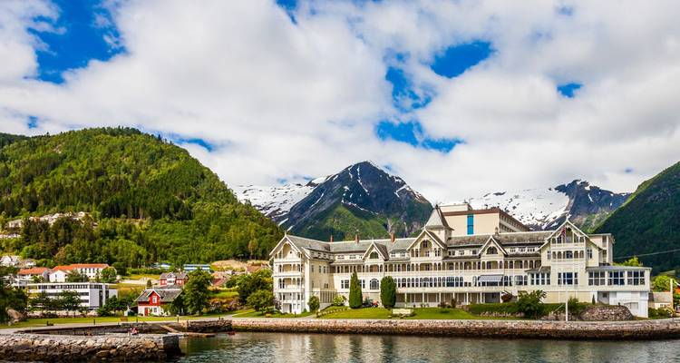 Grand wooden Kviknes Hotel sits on the fjord shore backed by forested hills and snow-capped peaks.