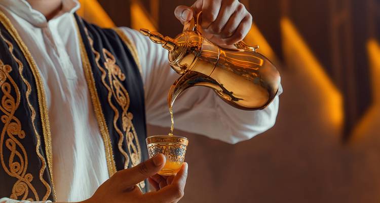 Traditional pouring ritual with ornate coffee pot
