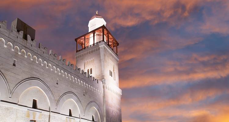 Historic mosque at sunset with dramatic sky