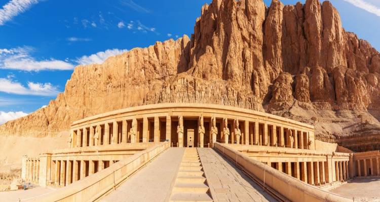 The majestic Mortuary Temple of Hatshepsut surrounded by towering cliffs.