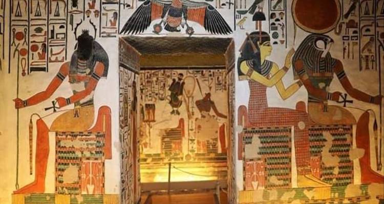 Vibrant mural paintings of ancient Egyptian deities on a temple wall.