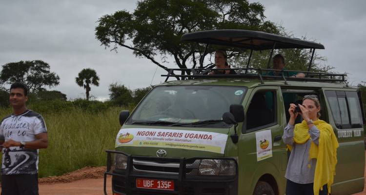 Tourists on a safari with a branded van.