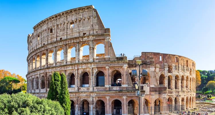 The Colosseum in Rome under a clear blue sky.