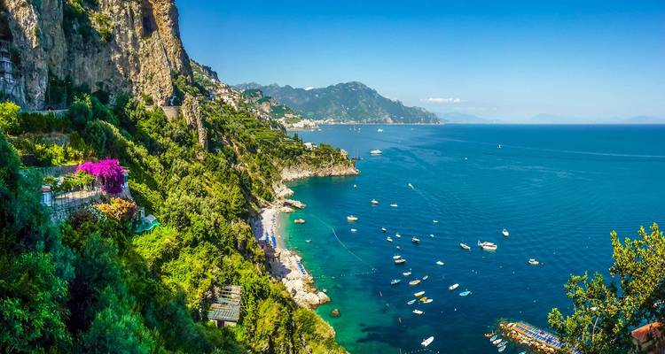 Panoramic view of a coastal town with clear blue sea.