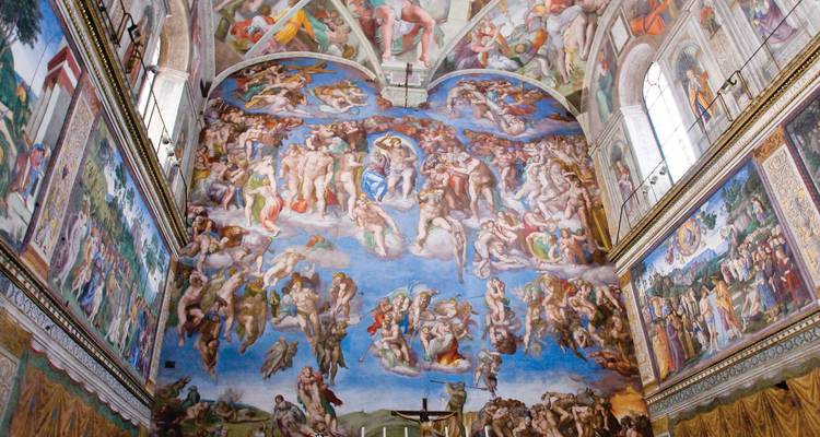 The Sistine Chapel ceiling with its ornate frescoes depicting biblical scenes.