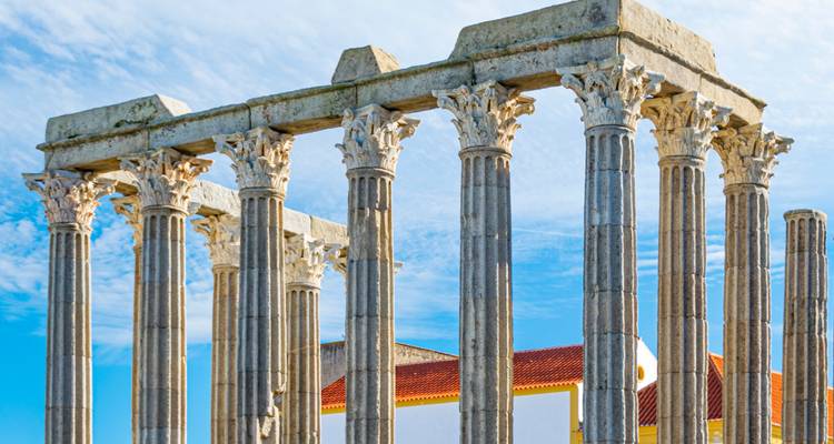 Roman temple ruins with a clear blue sky.