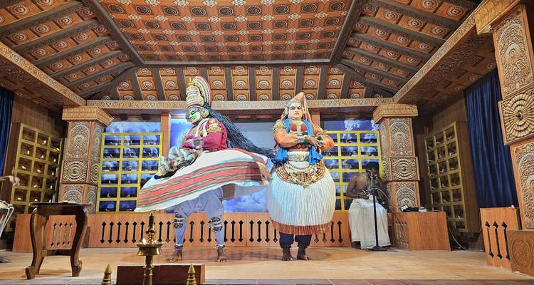 Two performers in traditional costume on stage.