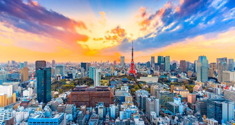 Tokyo skyline at sunset with the Tokyo Tower visible.