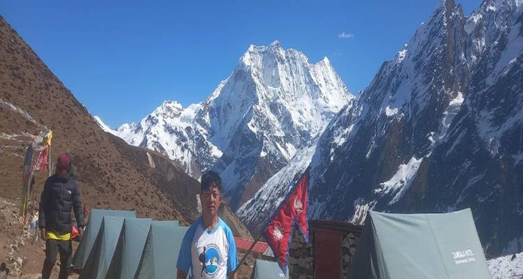 People standing in front of mountain tents