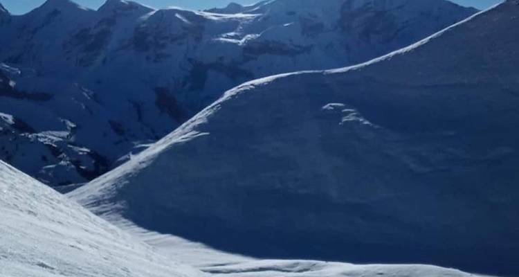 Snowy mountain landscape with bright sunshine