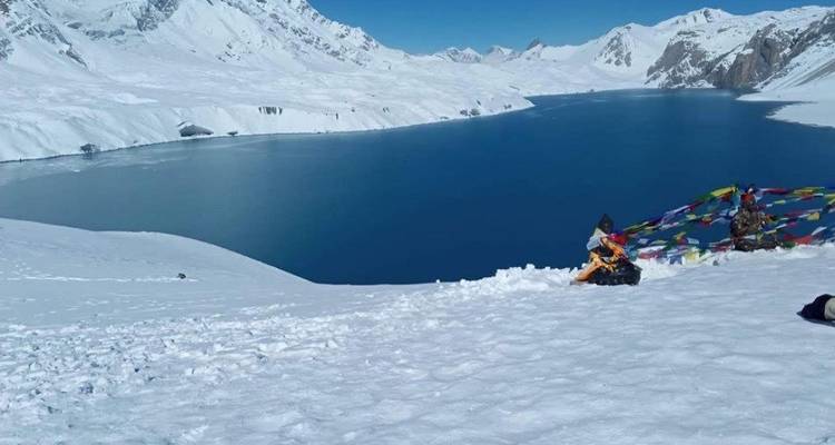 Snow-covered mountains with a clear lake