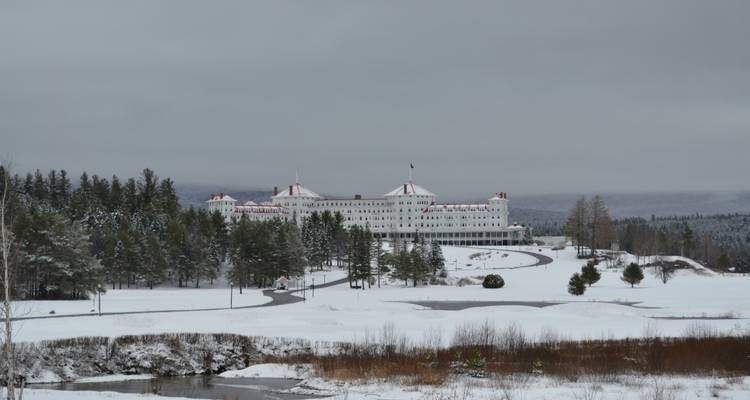 Snow-covered resort hotel in a mountainous area.