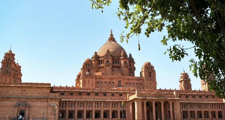 Grand sandstone Umaid Bhawan Palace stands under a clear blue sky in Jodhpur.