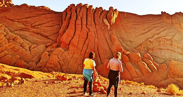 Travelers admire the striking orange rock formations known as Monkey Fingers in the Dades Gorge