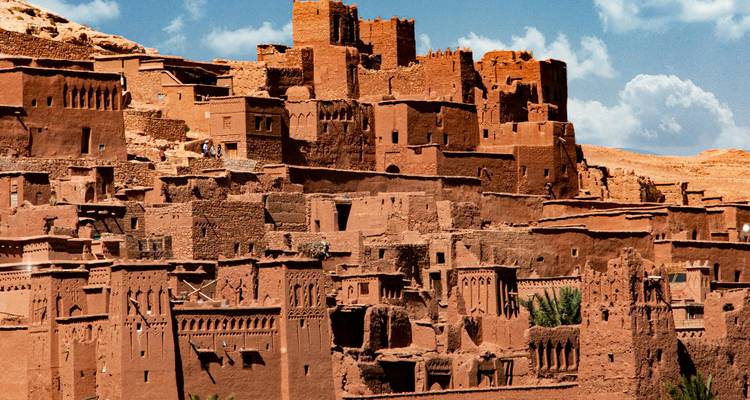 Detailed view of the adobe towers and crenellations of Ait Benhaddou under bright daylight