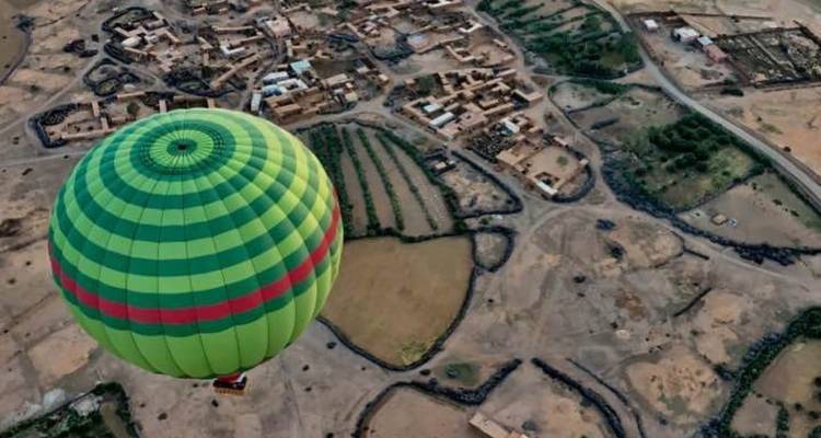 Montgolfière survolant un paysage rural.