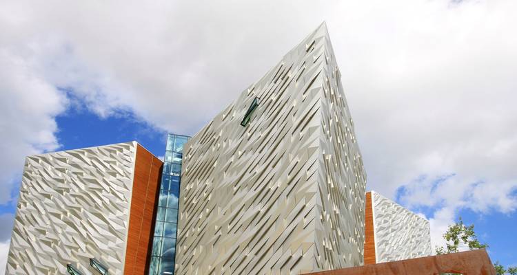 Modern architectural buildings with a cloudy sky in the background.