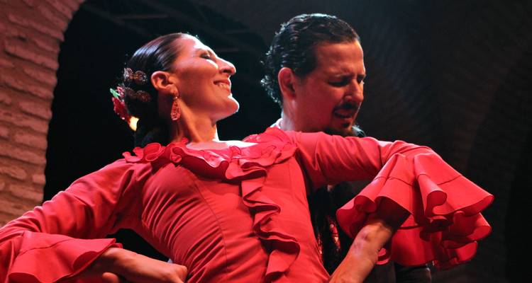 Flamenco dancers performing on a stage.