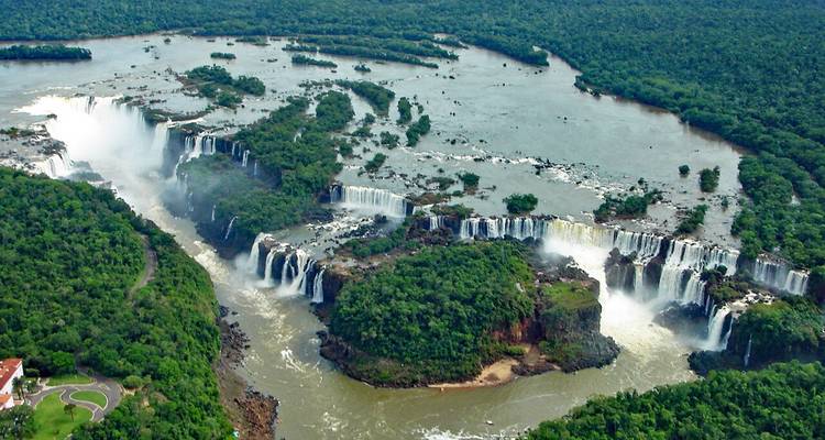 Spectacular aerial view of Iguazu Falls pouring through lush rainforest islands
