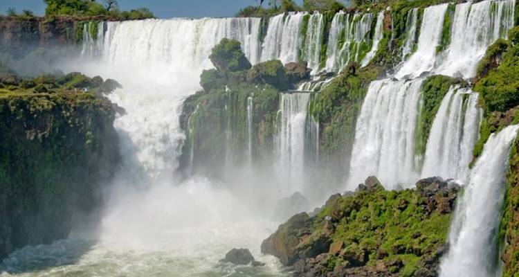 Close-up view of powerful cascades at Iguazu Falls surrounded by greenery
