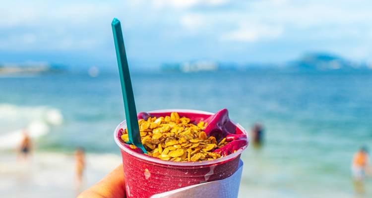Acai-Bowl vor einer Strandkulisse.
