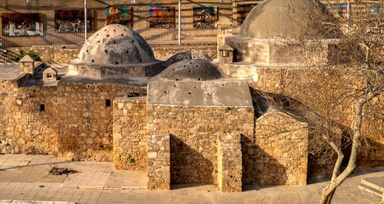 An ancient building with domed roofs made from stone and wood.