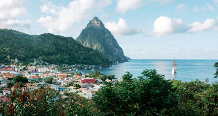Coastal view of a town with a mountain backdrop.