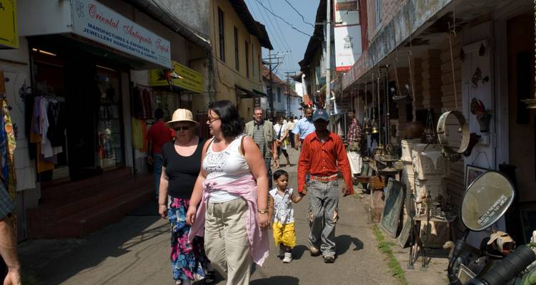 Busy street market with people and shops.