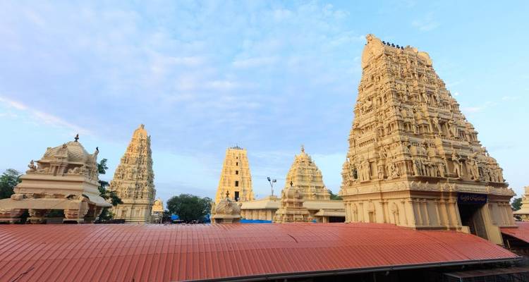 Temple complex with gopurams under blue sky.