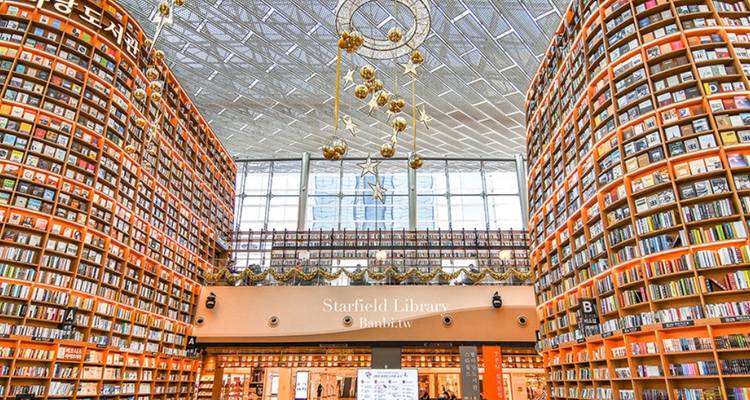 An extensive library with towering shelves packed with books.