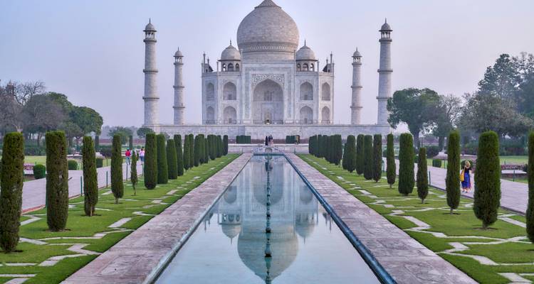 The Taj Mahal with its reflection in a long pool and garden path.