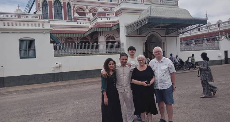 Group of people posing in front of a building.
