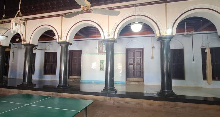Interior view of a house with columns and arches.