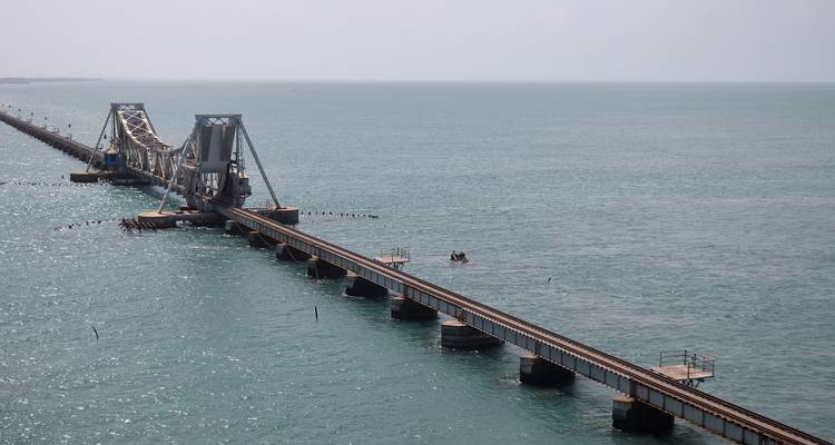 An extensive railway bridge stretching across the sea.