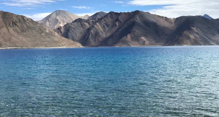 Blue Pangong Tso Lake with surrounding mountains.