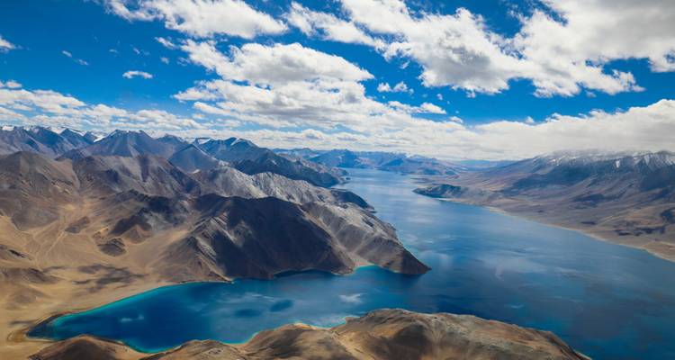 Aerial view of Pangong Tso Lake with a dramatic sky.